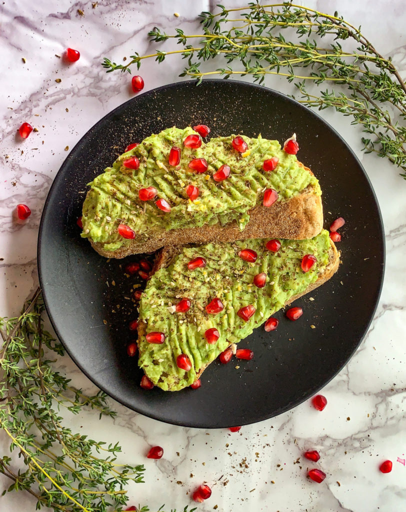 avocado toast with pomegranate and za'atar aerial view
