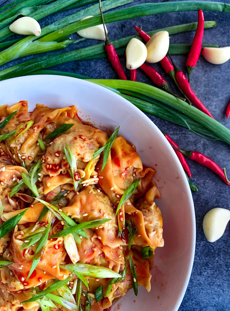 spicy wontons in chili scallion oil close
