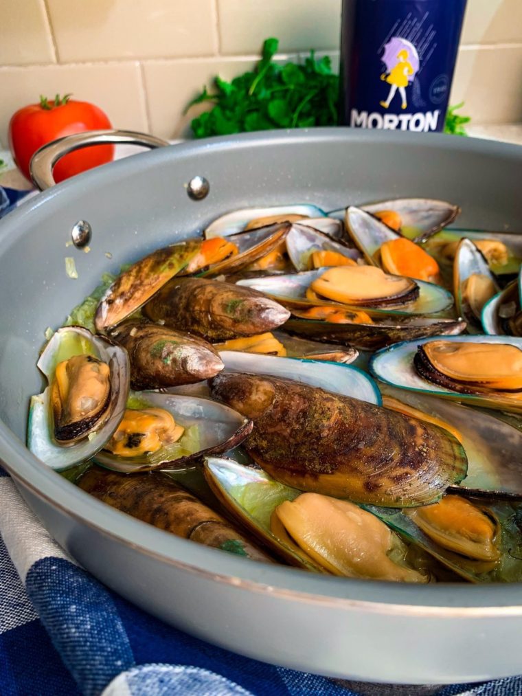 Steamed green shell mussels from the side with Morton salt