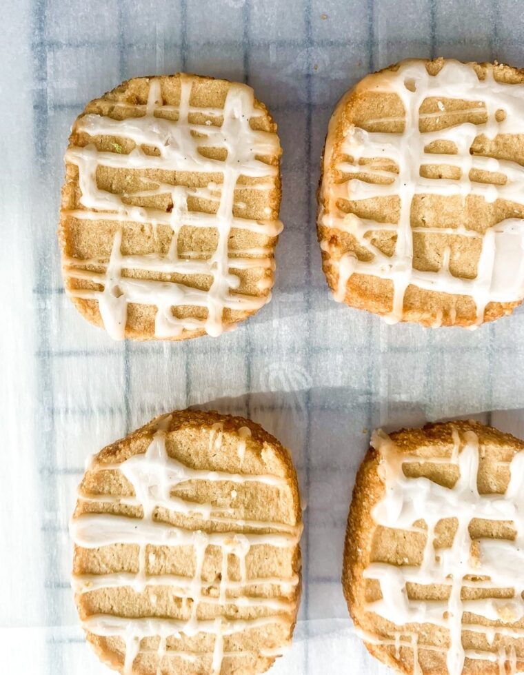 Aerial shot of 3 ingredient butter cookies with icing on a baking sheet.