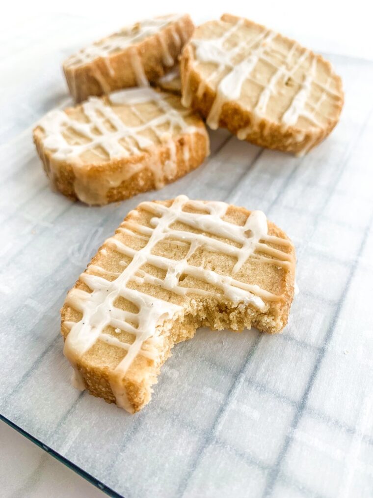 Close up shot of crunchy 3 ingredient butter cookies with a bite shot taken on the front cookie.