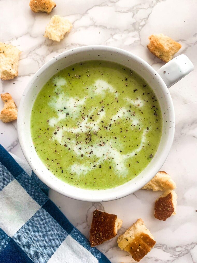 cream of broccoli soup close up shot with crusty bread