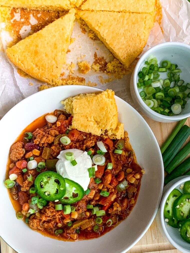 Bowl of 30 minute spicy chili with cornbread