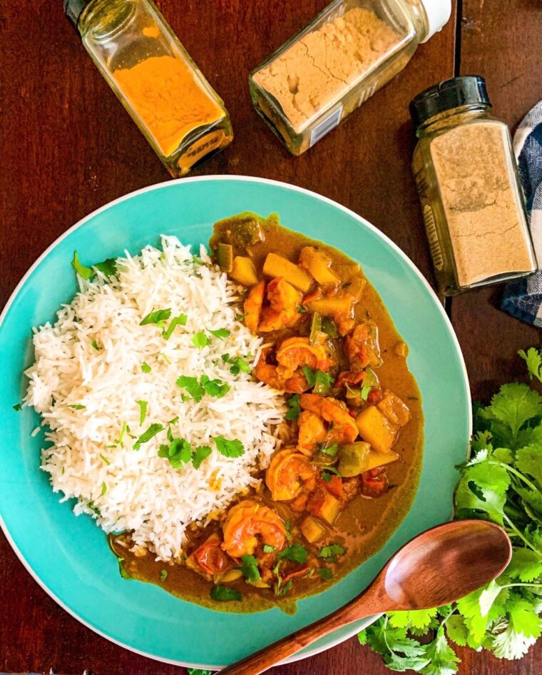 Jamaican curry shrimp with coconut milk on a blue plate