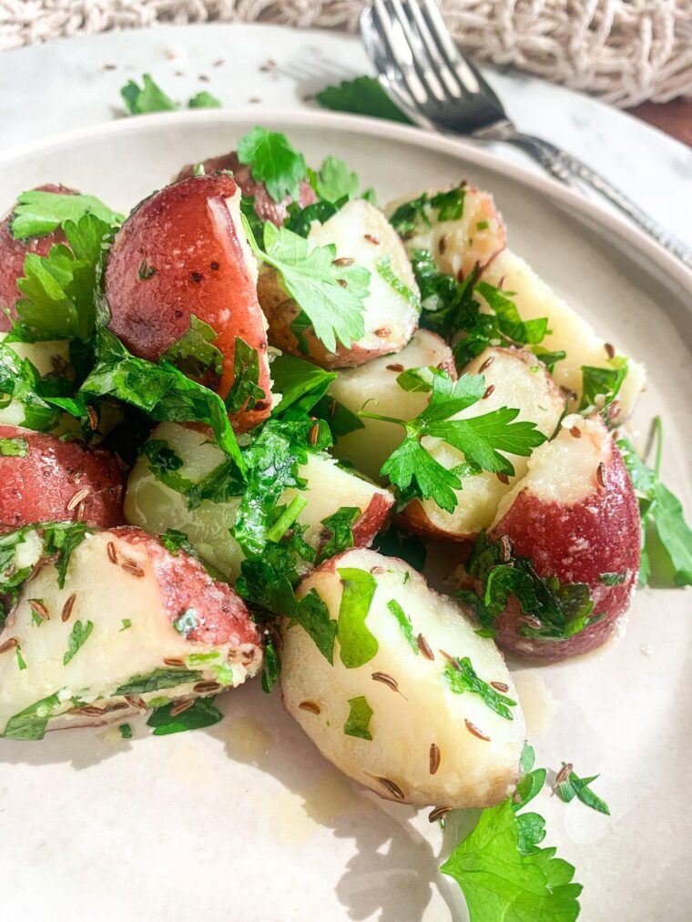 close up shot of red potato salad with caraway seeds