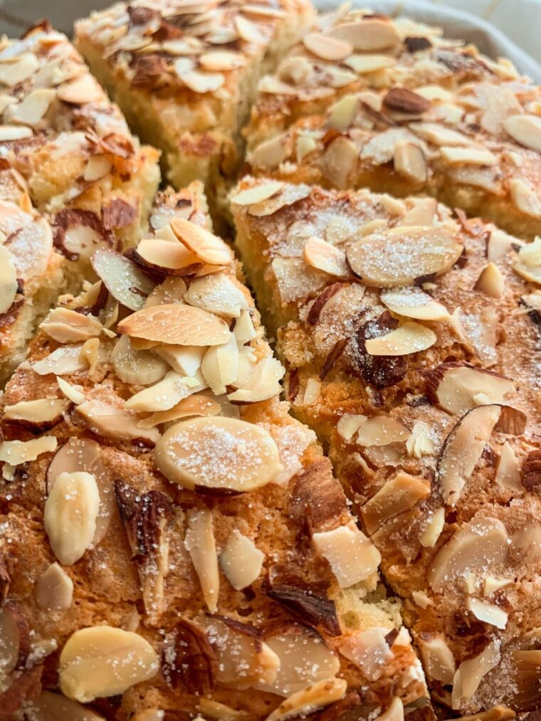 greek yogurt almond cake topped with flaked sugared almonds